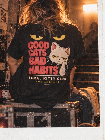 Instant photo of a seated model wearing the Good Cats Bad Habits tee